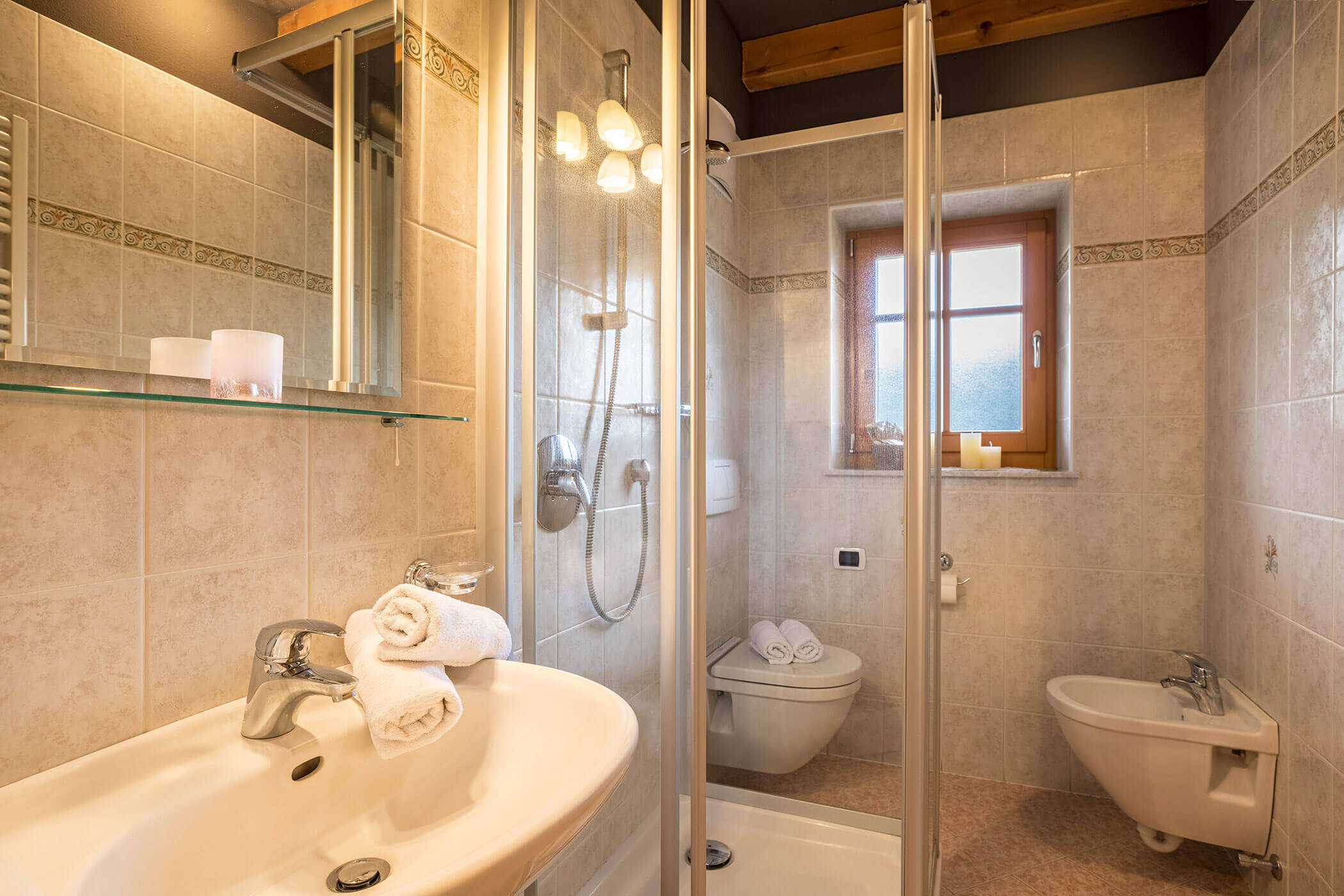 Bathroom in Apartment Brunico with washbasin, mirror, shower and WC - Oberplunerhof