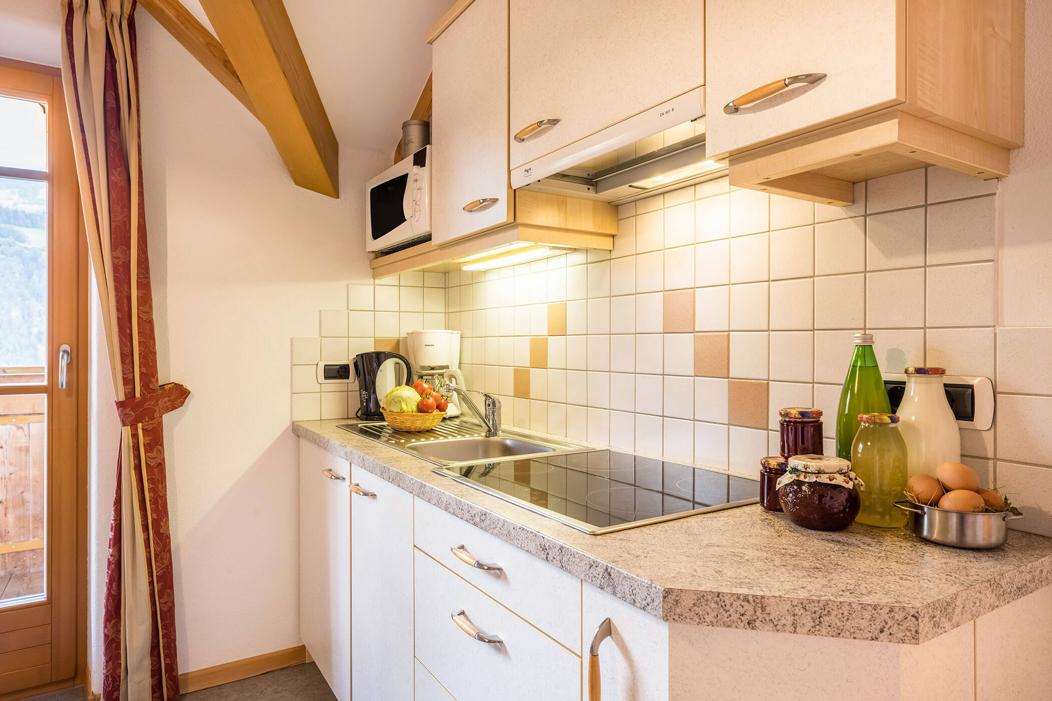 Kitchenette in Apartment Brunico with various juices, jam, fresh milk and eggs - Oberplunerhof